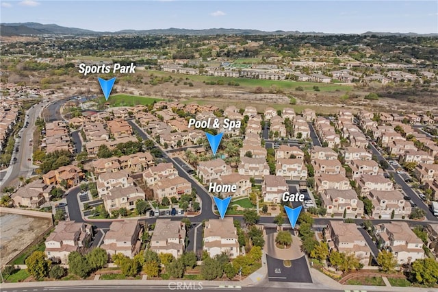 drone / aerial view featuring a residential view and a mountain view