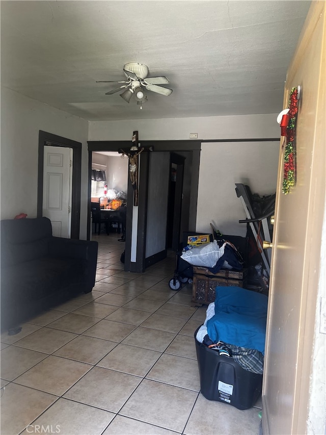 interior space with light tile patterned floors and ceiling fan