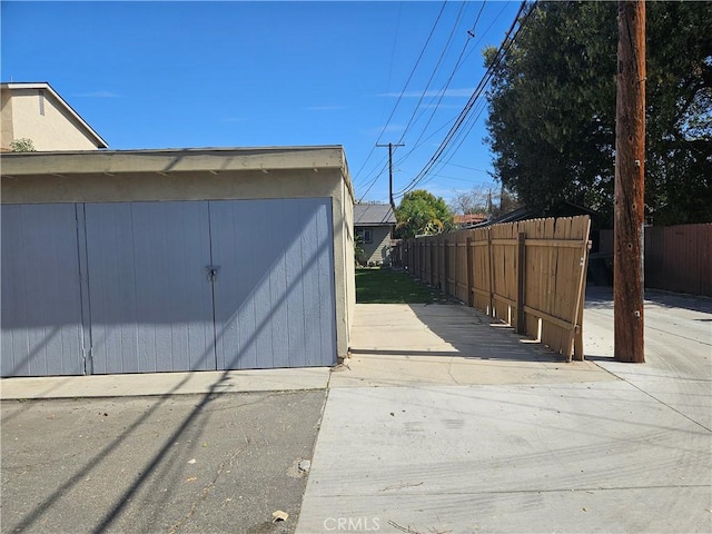 view of outbuilding with fence and an outdoor structure