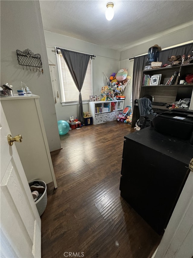 office area with a textured ceiling and wood finished floors