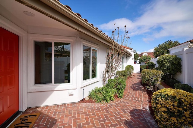 view of side of home featuring a patio area and fence