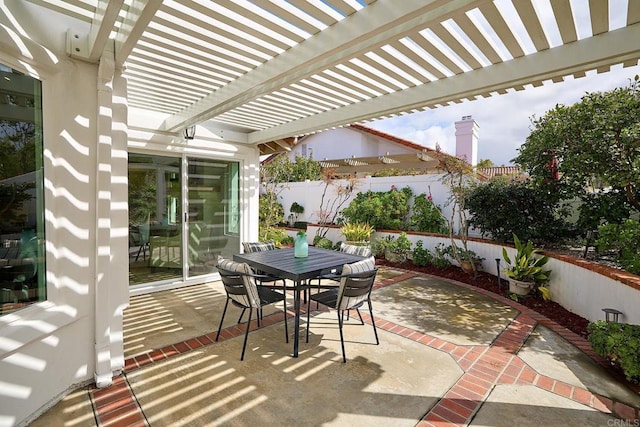 view of patio featuring outdoor dining space, a fenced backyard, and a pergola