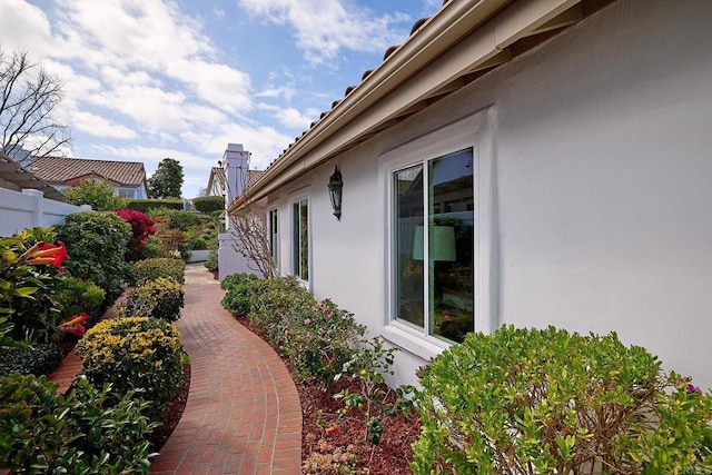 view of home's exterior featuring fence and stucco siding