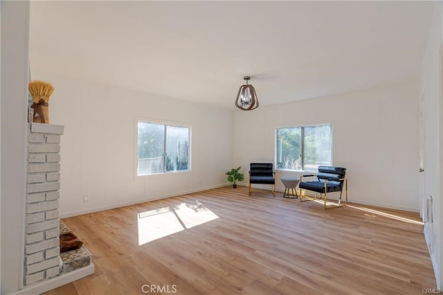 unfurnished room with light wood-style flooring and baseboards