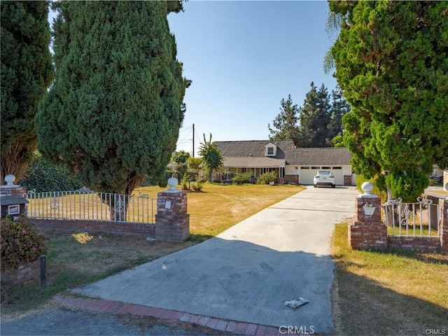 view of front of house with fence, a front lawn, and concrete driveway