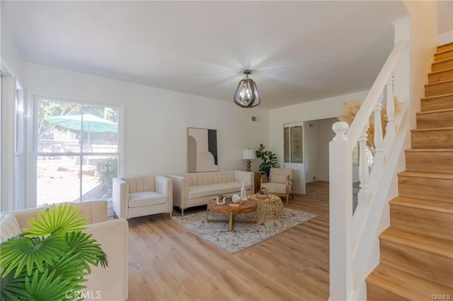 living room with stairs and wood finished floors