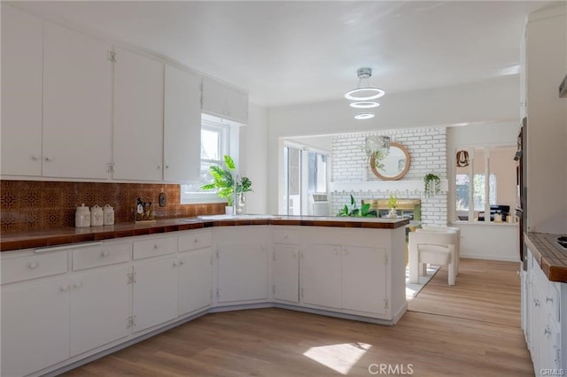 kitchen featuring tasteful backsplash and white cabinetry