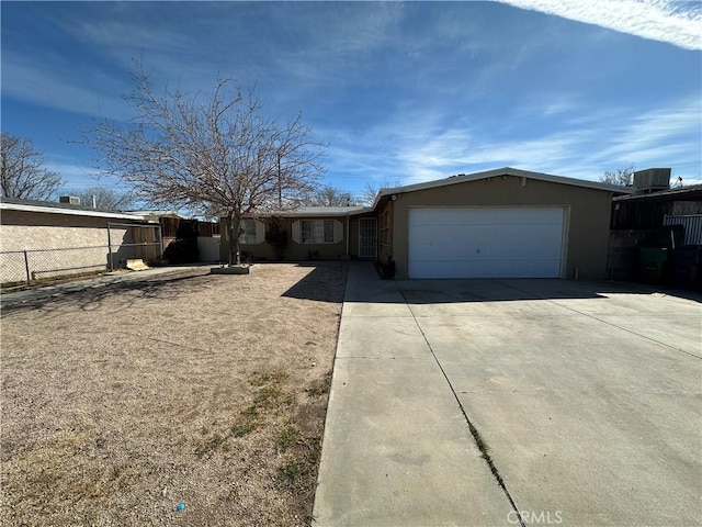 view of front of house featuring a garage, concrete driveway, fence, central air condition unit, and stucco siding