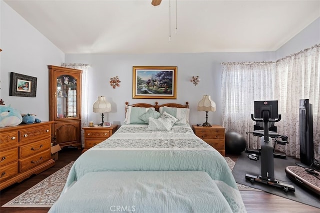 bedroom featuring ceiling fan, vaulted ceiling, and dark wood finished floors