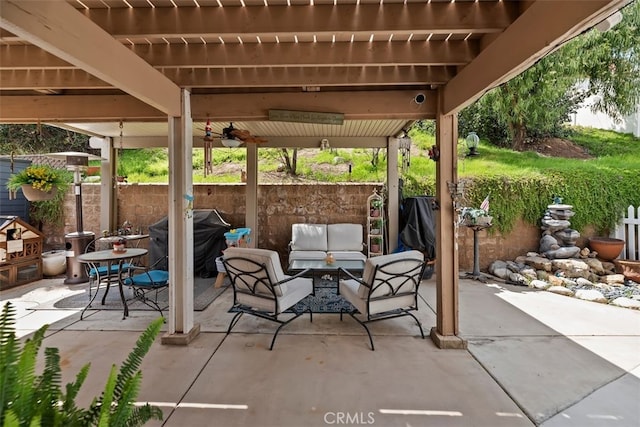 view of patio featuring an outdoor hangout area, fence, and grilling area
