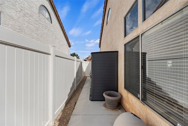 view of home's exterior with stucco siding and fence