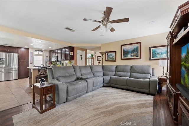 living area with a ceiling fan, recessed lighting, light wood-style floors, and visible vents