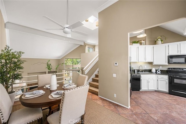 dining room with a ceiling fan, lofted ceiling with beams, baseboards, and stairs