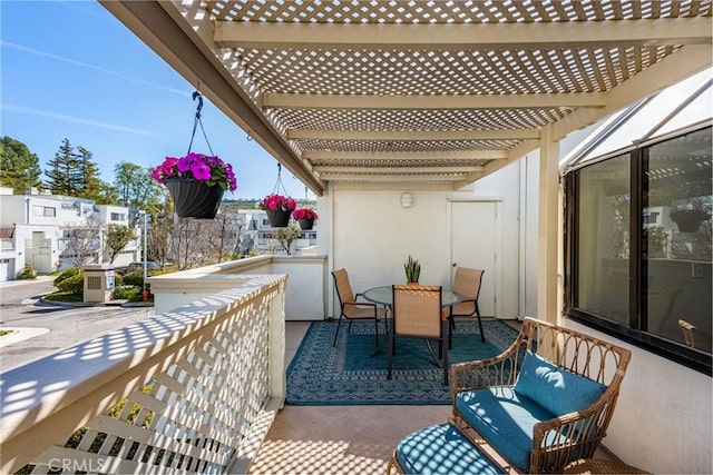 balcony with a patio, outdoor dining space, a sunroom, and a pergola