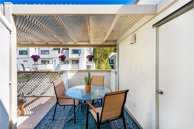 balcony featuring outdoor dining space and a pergola