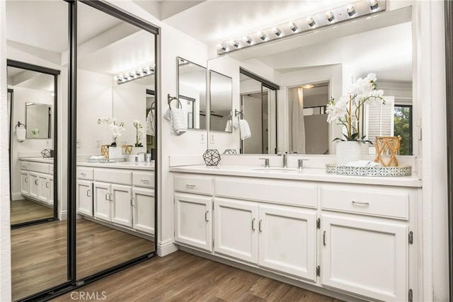 full bath with wood finished floors and vanity