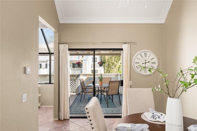 dining space featuring light tile patterned floors, baseboards, and ornamental molding