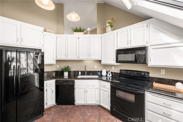 kitchen featuring black appliances, pendant lighting, white cabinets, and a sink