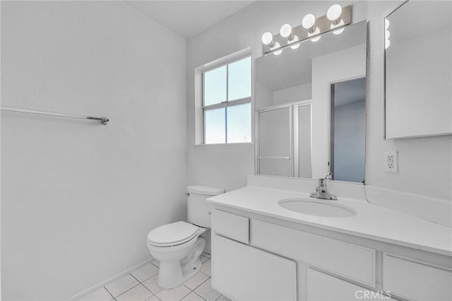 bathroom with toilet, a shower stall, vanity, and tile patterned floors