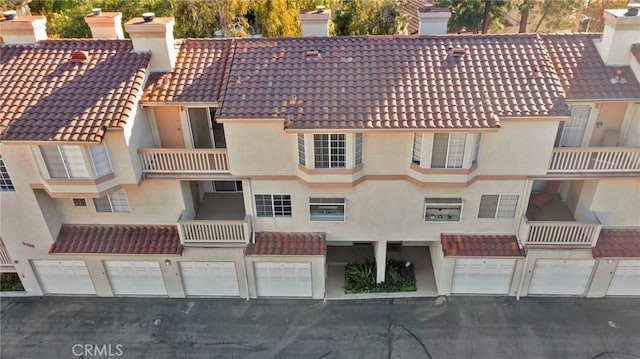 view of property featuring a garage and driveway