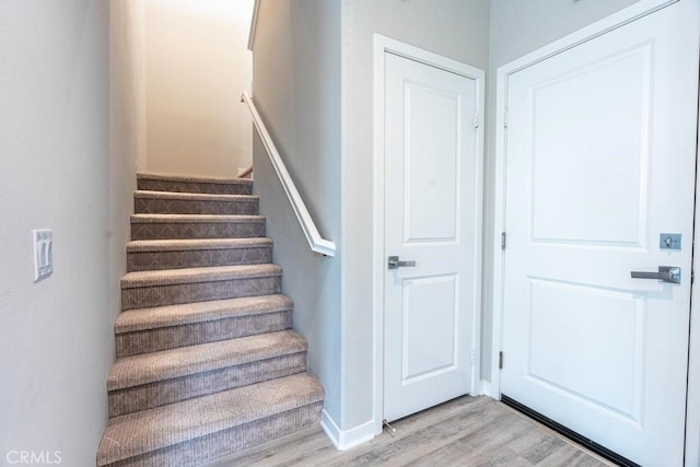 staircase featuring wood finished floors