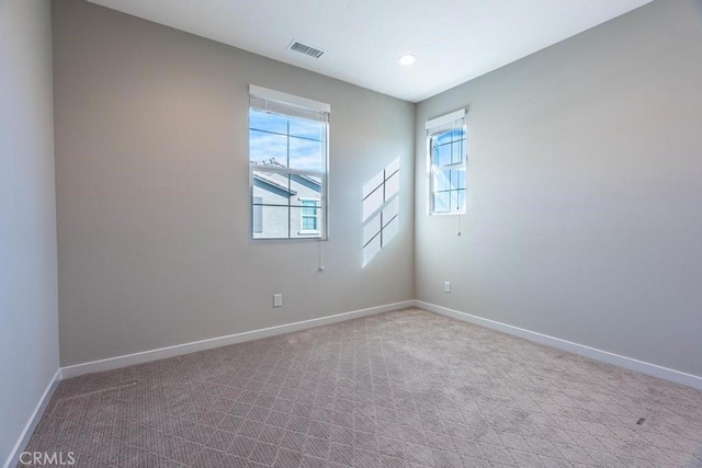 carpeted spare room with recessed lighting, visible vents, and baseboards