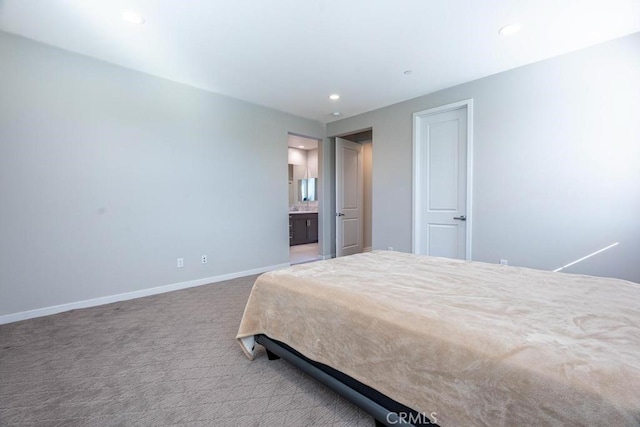 carpeted bedroom featuring baseboards, ensuite bathroom, and recessed lighting