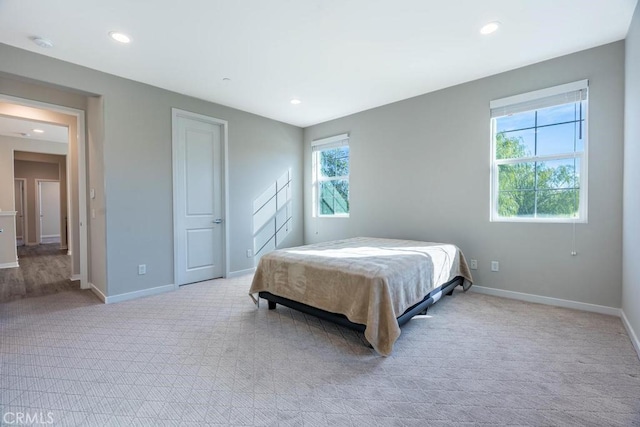 bedroom featuring light carpet, baseboards, and recessed lighting