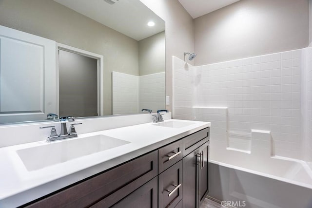 full bathroom with shower / washtub combination, recessed lighting, a sink, and double vanity