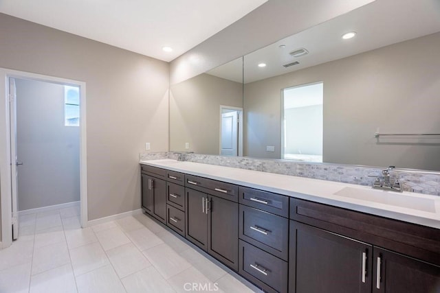 full bath with recessed lighting, a sink, baseboards, and double vanity