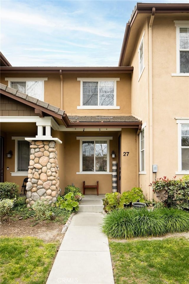 entrance to property with stucco siding