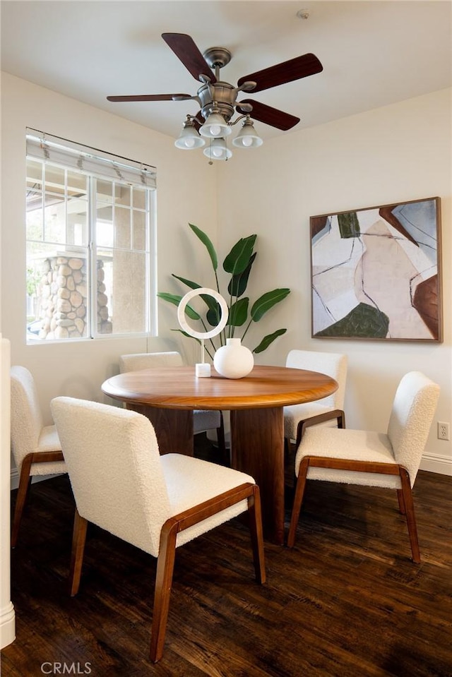 dining room featuring ceiling fan, baseboards, and wood finished floors