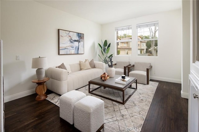 living area featuring baseboards and hardwood / wood-style flooring