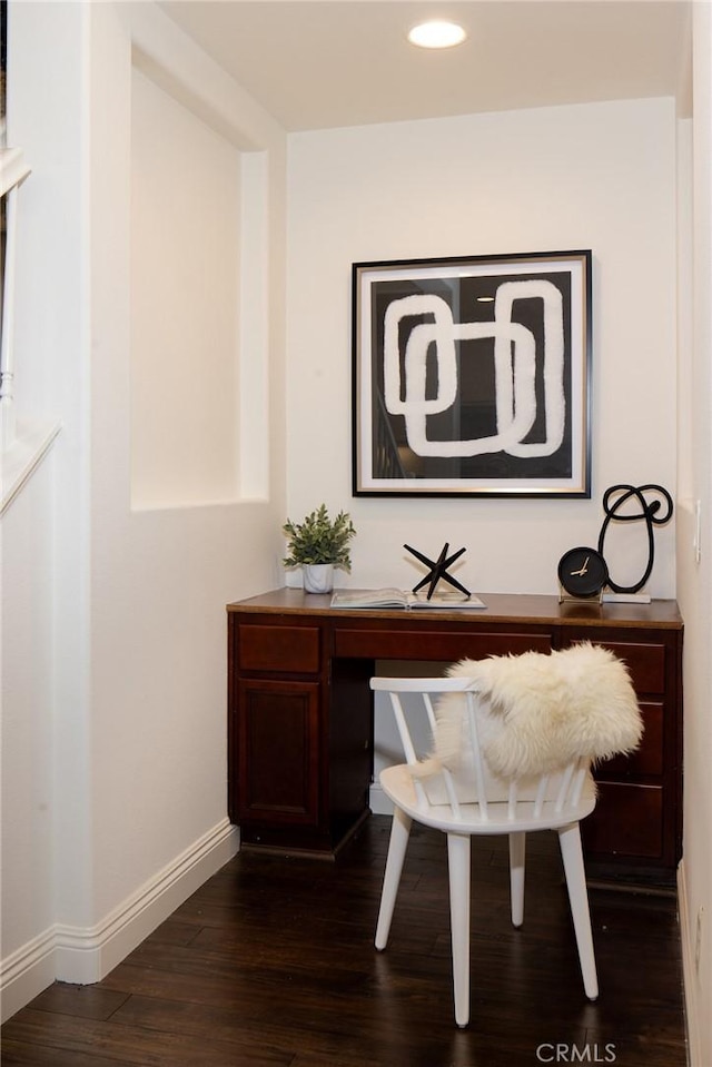 home office with dark wood-style flooring and baseboards