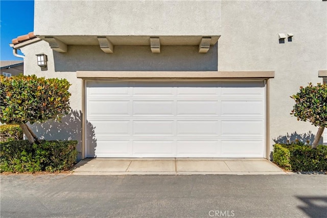 garage with concrete driveway