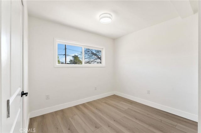 unfurnished room with light wood-style floors and baseboards