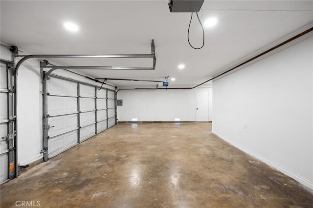 garage with a garage door opener and baseboards