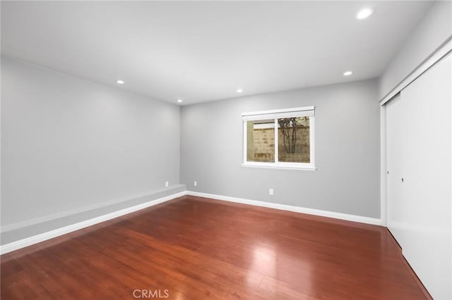 interior space featuring recessed lighting, baseboards, and wood finished floors