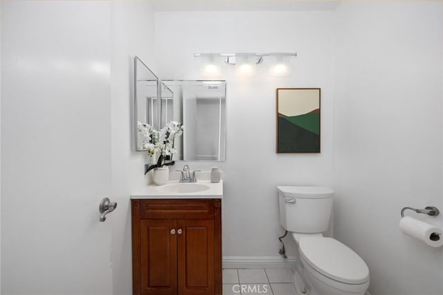 bathroom featuring tile patterned floors, baseboards, toilet, and vanity