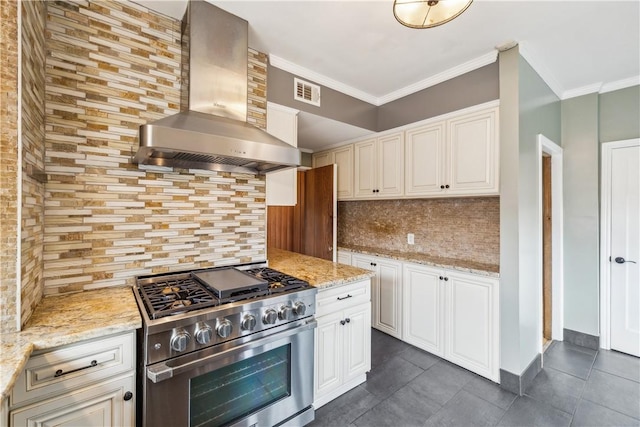 kitchen with visible vents, wall chimney exhaust hood, ornamental molding, high end range, and backsplash