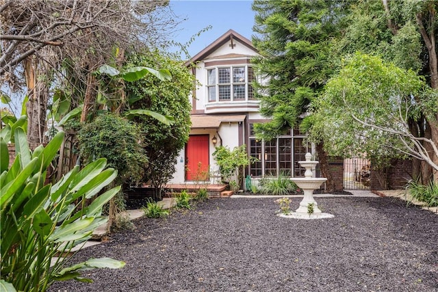 view of front of property with fence and stucco siding