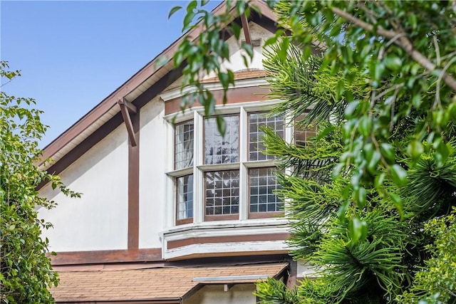 view of side of home with stucco siding