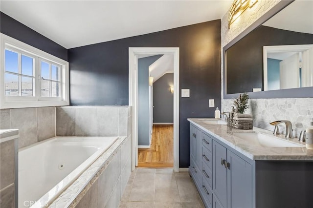 2749 E 17th St, Oakland, CA 94601 - bathroom with double vanity, a jetted tub, tile patterned floors, and backsplash