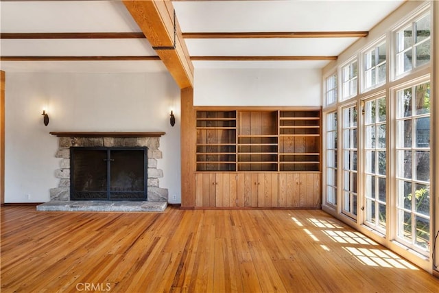 2749 E 17th St, Oakland, CA 94601 - unfurnished living room featuring wood-type flooring, beamed ceiling, and a fireplace
