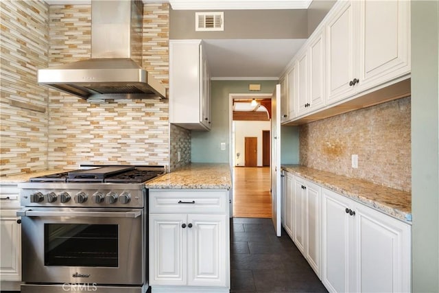 2749 E 17th St, Oakland, CA 94601 - kitchen featuring high end stainless steel range oven, wall chimney exhaust hood, decorative backsplash, crown molding, and white cabinets