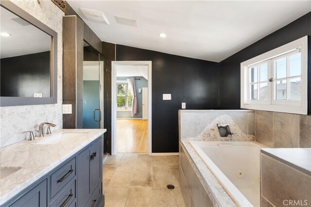 2749 E 17th St, Oakland, CA 94601 - full bath featuring double vanity, a tub with jets, tasteful backsplash, lofted ceiling, and tile patterned flooring