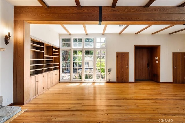 2749 E 17th St, Oakland, CA 94601 - unfurnished living room featuring beam ceiling and hardwood / wood-style floors