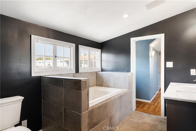 2749 E 17th St, Oakland, CA 94601 - bathroom featuring a garden tub, tile patterned flooring, vaulted ceiling, and double vanity