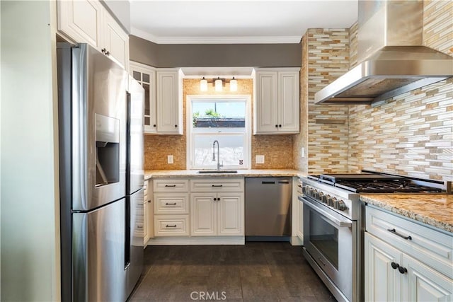 2749 E 17th St, Oakland, CA 94601 - kitchen featuring appliances with stainless steel finishes, wall chimney range hood, dark wood finished floors, white cabinetry, and crown molding