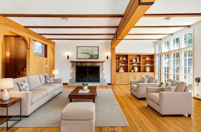 2749 E 17th St, Oakland, CA 94601 - living area featuring beamed ceiling, wood finished floors, stairway, and a fireplace